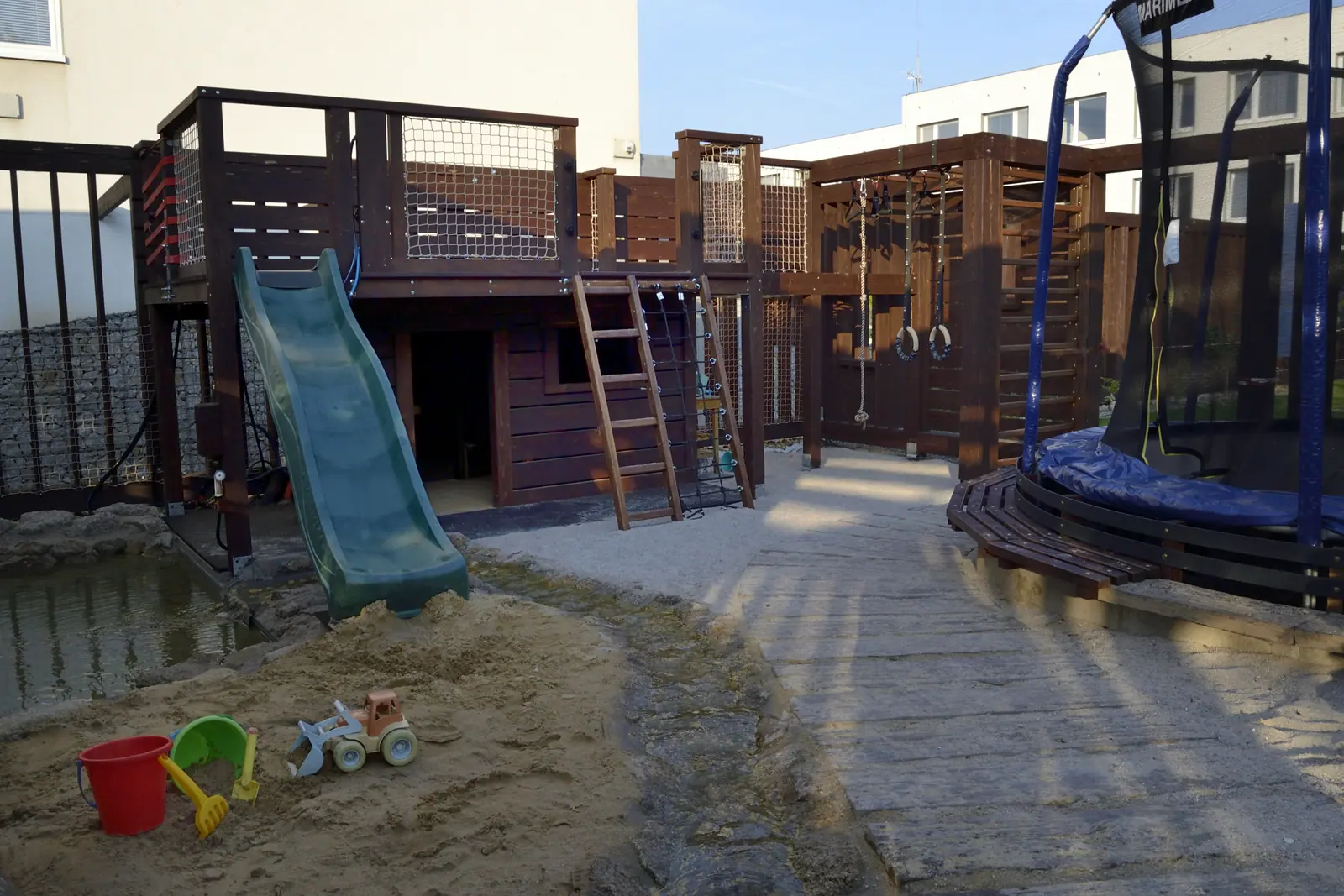 Dětské hřiště se skluzavkou, trampolínou a pískovištěm
